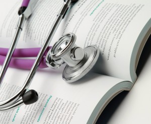 book and stethoscope isolated on white background