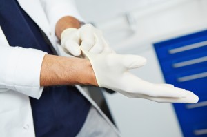 Dentist putting on gloves