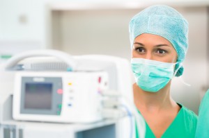 Doctor or nurse in operating room on heart monitor