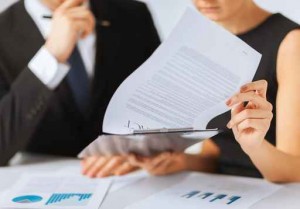 man and woman signing contract paper