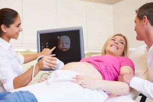 Pregnant Woman And Partner Having 4D Ultrasound Scan